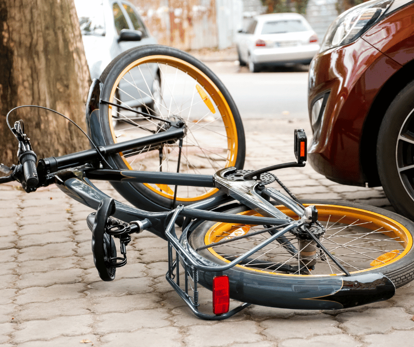 Cyclist riding near traffic.
